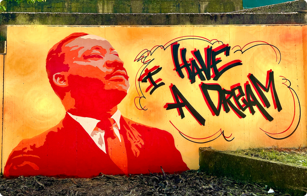 opera dello streetartist Goran Castellotti raffigurante la frase I HAVE A DREAM e il volto di Malcom X